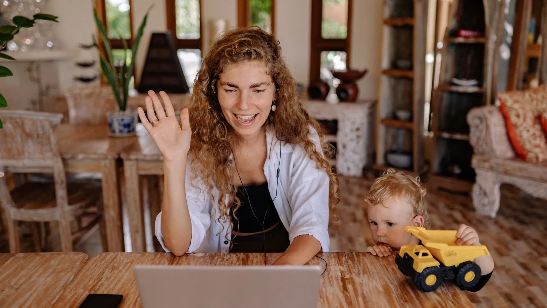 A mother and her son engaging in a joyful video call, sharing a family moment at home.